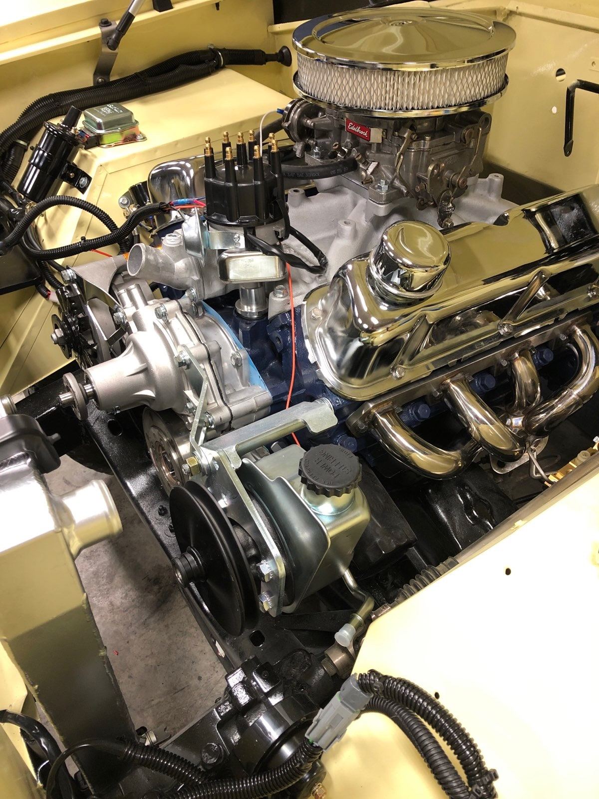 Rebuilt Ford 302 V8 with chrome air cleaner and headers, viewed from above