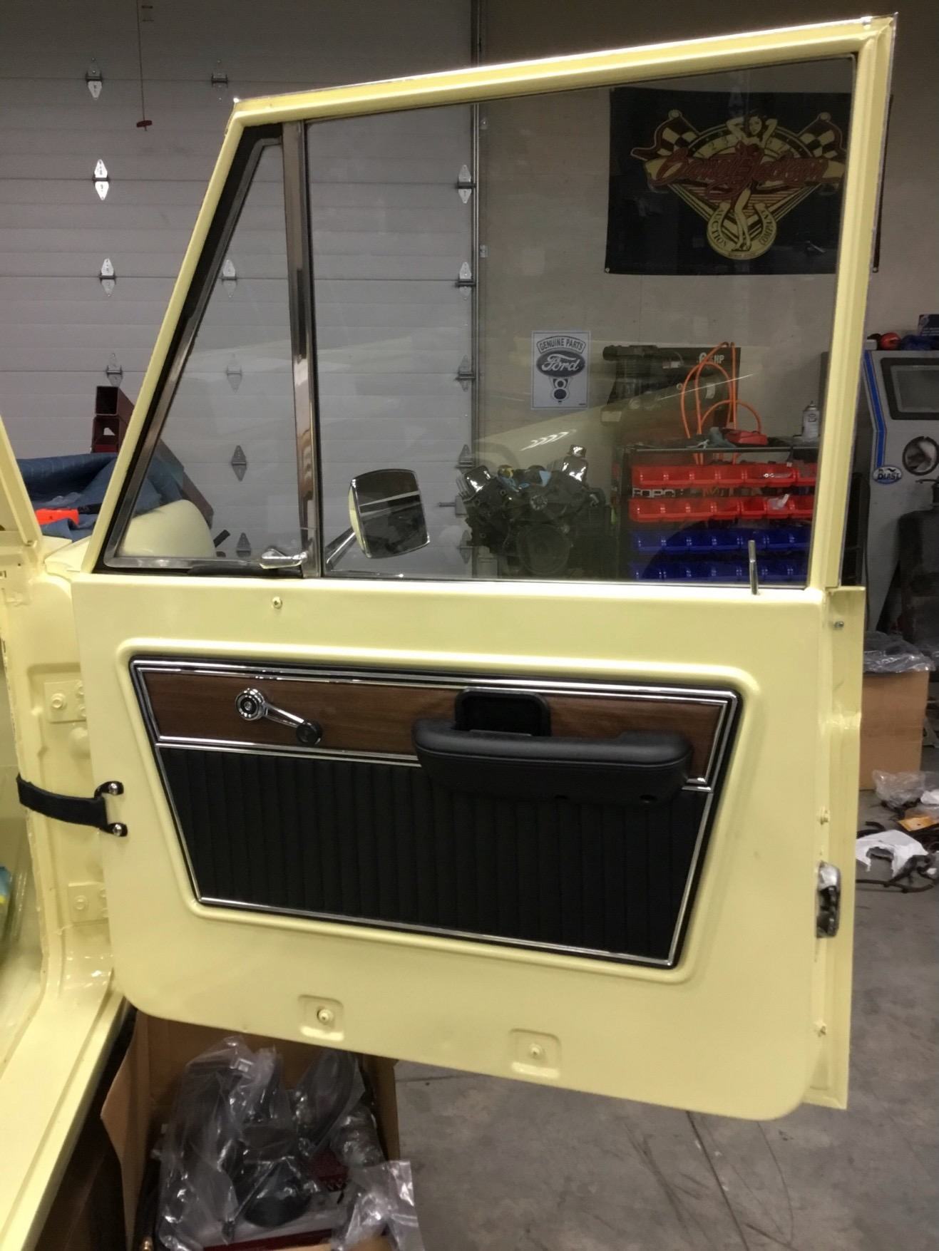 Door in fresh yellow paint with restored trim panel