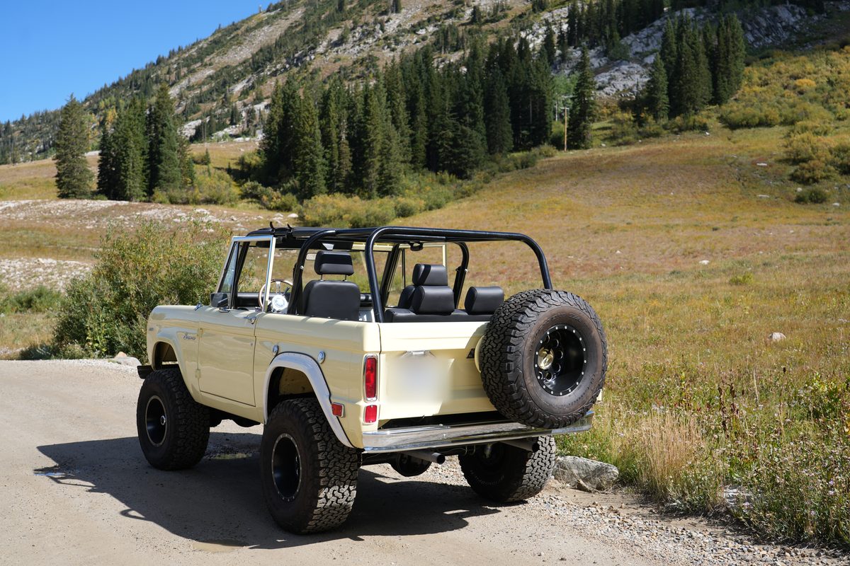 Rear three-quarter view showing the rear-mounted full-size KO2 spare, roll cage and tailgate